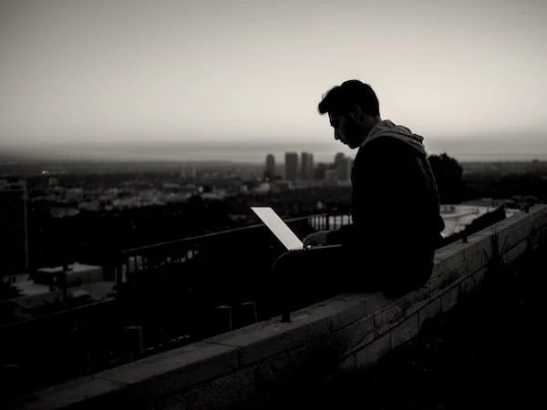 Person with laptop on roof