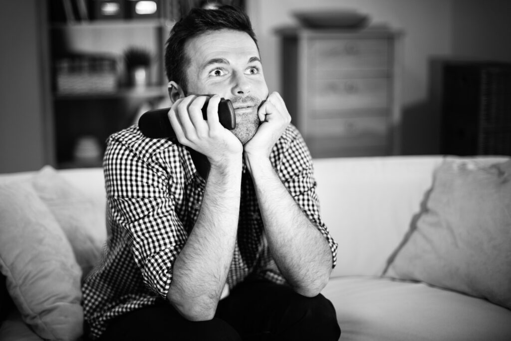 man on couch watching TV